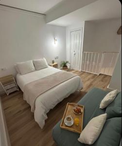 a hotel room with a large bed and a couch at Las Marismas-Puente del Rey in El Rocío +19 photos