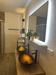 two sinks in a bathroom with a mirror at Woidzeit by Sigl in Kollnburg +24 photos