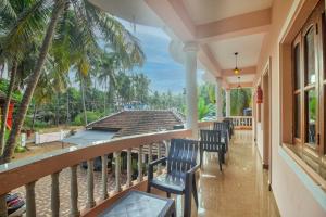 a balcony with chairs and a view of the ocean at Hotel Calangute bay in Calangute