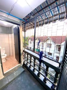 a person standing in a prison cell looking out the window at J&T House And Friends in Ban Khlong Nam Ron +81 photos
