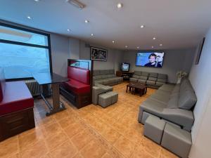 a large living room with a flat screen tv at Hotel Guineu in Pas de la Casa