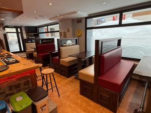 a restaurant with a bar and some chairs and tables at Hotel Guineu in Pas de la Casa