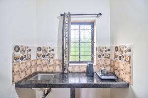 a kitchen with a sink and a window at Hotel Calangute bay in Calangute