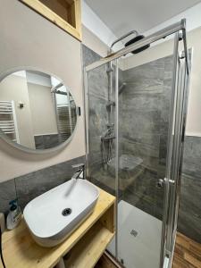 a bathroom with a sink and a shower at Lilli apartment in Aprica