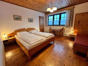 a bedroom with a bed and a table in it at Ferienhof Stanzl in Rappottenstein