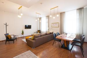 a living room with a couch and a table at Bearsleys Downtown Apartments in Riga