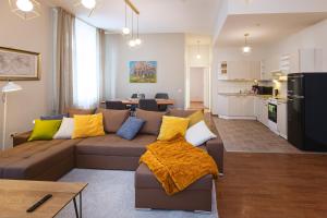 a living room with a couch and a kitchen at Bearsleys Downtown Apartments in Riga