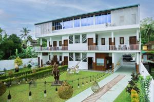 a house with a statue in front of it at Grand Ranketha Resort in Kalutara