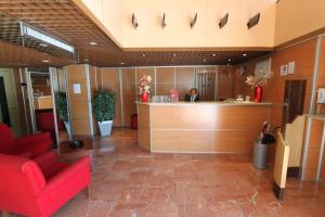 a lobby with a woman at a counter in a hospital at Hotel Real in Lleida