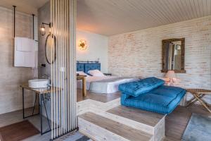 a bedroom with a bed and a blue couch at St Anastasia Hotel in Burgas +132 photos