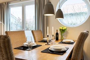 a dining room table with chairs and a large window at Rapsblütenhaus in Bohnert