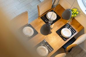 a wooden table with white plates on top of it at Rapsblütenhaus in Bohnert