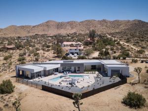 an aerial view of a house in the desert at Orchid by Fieldtrip Architectural Estate w Pool Spa Game Room in Yucca Valley