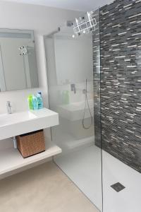 a bathroom with a shower and a sink and a toilet at Lirios 182 Cumbre del Sol in Benitachell +9 photos
