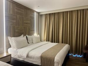 a hotel room with a large bed and a window at Mass Paradise Hotel in Aqaba