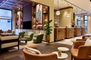 a lobby of a hotel with chairs and tables at Berlin Marriott Hotel in Berlin