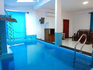 a large swimming pool with a blue tile floor at Wadula Resort in Nochchiyagama