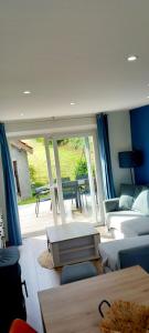 a living room with a couch and a table at Maison l'Escale du port in Berville-sur-Mer