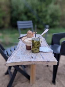 a wooden table with a bowl of food on it at Camping le Kergorz in Plomodiern