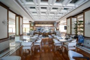 a restaurant with tables and chairs and a bar at Casa Solada Cunda Resort & Spa in Ayvalık