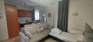 a living room with a couch and a kitchen at Harmony 3 in Artemida