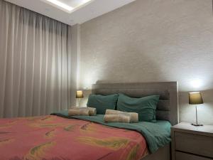 a bedroom with a large bed with two pillows at Behind the Parliament Building in Tbilisi City
