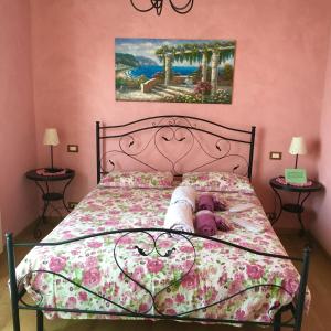 a bedroom with a bed with a pink wall at Villa Gaia - Luxury Villa, pool & wellness rooms in Bordighera +120 photos