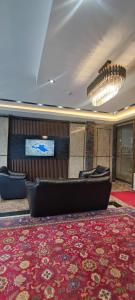 a lobby with a couch on a red rug at Ada Mevan Otel in Ipekyolu
