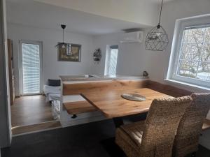 a kitchen with a wooden table in a room at Apartment Amy in Podčetrtek