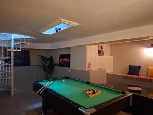 a living room with a pool table in it at Behind the Parliament Building in Tbilisi City