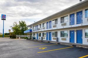 a building with blue doors in a parking lot at Motel 6-Rochester, MN in Rochester