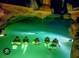 a group of people in the water at night at Phong Nha Cherish House in Phong Nha
