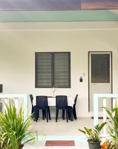 a dining room with a table and chairs at Surfside Bungalows in General Luna