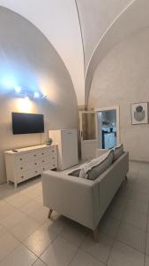 a living room with a couch and a tv at Celebes in Brindisi +7 photos