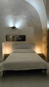 a bedroom with a large bed with two night stands at Celebes in Brindisi