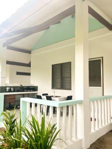 a kitchen and dining area of a house with a white railing at Surfside Bungalows in General Luna +8 photos