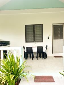 a dining room with a table and chairs at Surfside Bungalows in General Luna