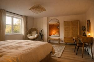 a bedroom with a bed and a desk and a mirror at Le lofty in Stoumont