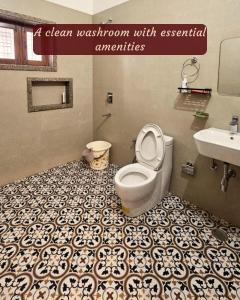 a bathroom with a white toilet and a sink at Ashiana By Ijabojyu- Pet friendly Homestay in Dehradun +2 photos