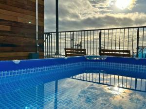 a swimming pool with a view of the ocean at MARSOL CS Beach Hotel in Chigasaki