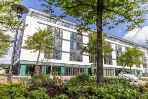 an office building with trees in front of it at Hotel Kolding in Kolding
