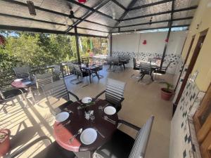 an overhead view of a patio with tables and chairs at Navya Homestay and Restaurant in Jāmb