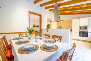 a dining room and kitchen with a table and chairs at Sant Antoni 39 in Llucmajor +34 photos