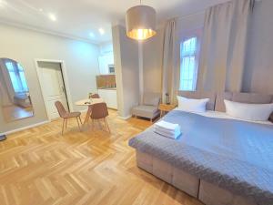 a bedroom with a bed and a table and chairs at Alter Bahnhof Stötteritz in Leipzig