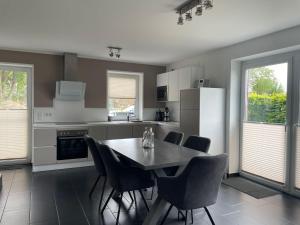 a kitchen with a table and chairs in it at Ferienhaus Hilgenhuus in Hilgenriedersiel