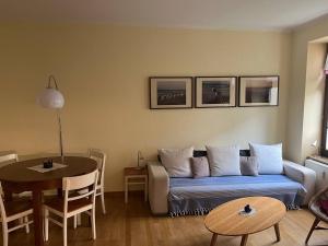 a living room with a couch and a table at Bastians Herberge in Leipzig
