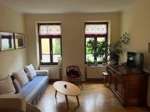 a living room with a couch and a table at Bastians Herberge in Leipzig