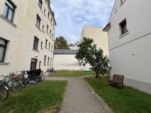 a walkway between two buildings with bikes parked between them at Bastians Herberge in Leipzig