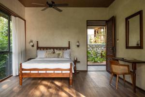 a bedroom with a bed and a large window at CardMem Hills View Pool Villa & Resort, Thekkady in Thekkady +46 photos
