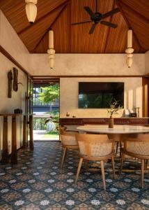 a dining room with a table and chairs and a ceiling at CardMem Hills View Pool Villa & Resort, Thekkady in Thekkady